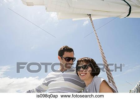 Smiling couple on a sailing boat View Large Photo Image Stock Photography - Smiling couple on a sailing boat. Fotosearch