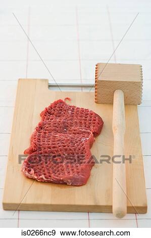 Stock Photo - Steak and a meat tenderiser. Fotosearch