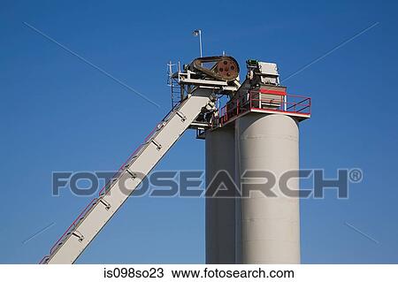 Stock Image - Storage tank and conveyor. Fotosearch