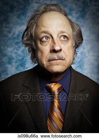 Stock Image - Studio portrait of balding senior man. Fotosearch