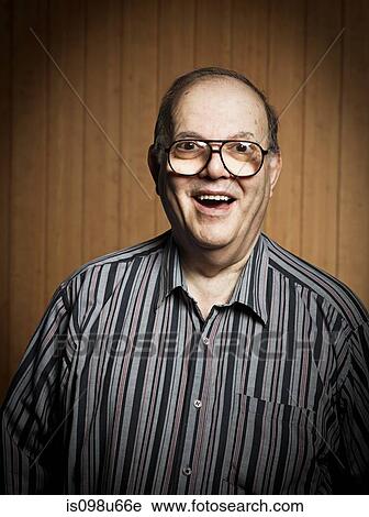 Stock Image - Studio portrait of cheerful senior man. Fotosearch