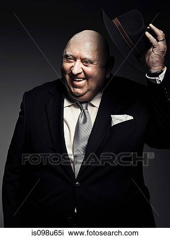 Studio portrait of gangster holding hat View Large Photo Image Stock Image - Studio portrait of gangster holding hat. Fotosearch