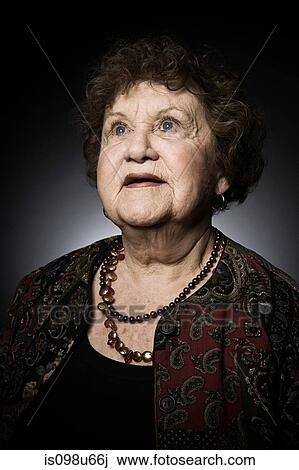 Studio portrait of senior woman looking up View Large Photo Image Stock Image - Studio portrait of senior woman looking up. Fotosearch