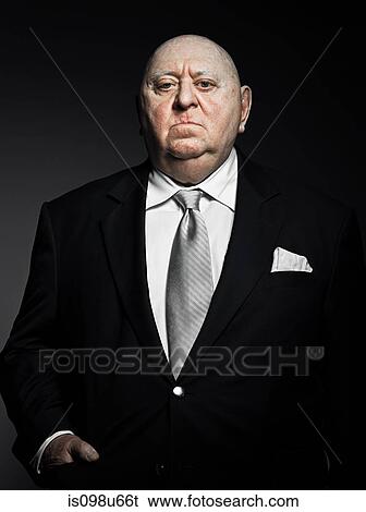 Stock Photograph - Studio portrait of serious gangster. Fotosearch