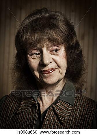 Stock Image - Stuido portrait of cheerful senior woman. Fotosearch