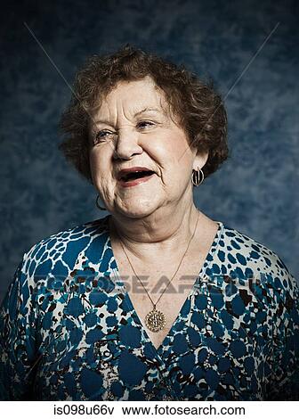 Stock Photo - Stuido portrait of cheerful senior woman. Fotosearch