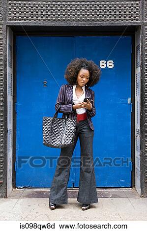 Stock Image - Stylish woman with cellphone. Fotosearch
