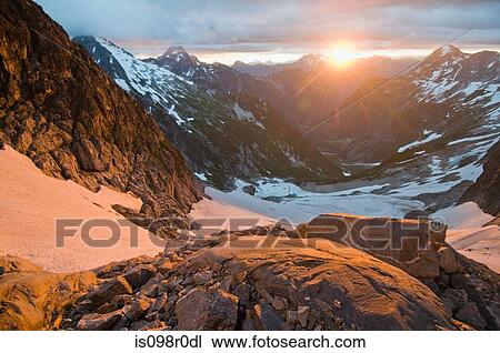 Stock Image - Sun rising over north cascades national park. Fotosearch