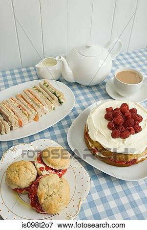 Stock Photo - Tea with sandwiches and cakes. Fotosearch
