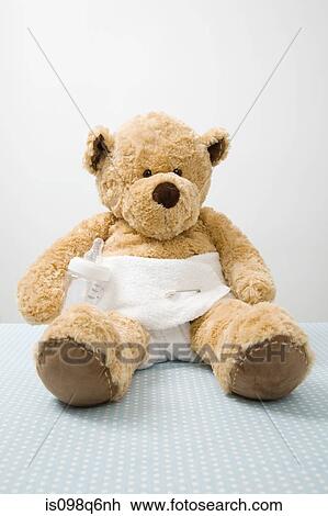 Stock Image - Teddy bear in a diaper. Fotosearch