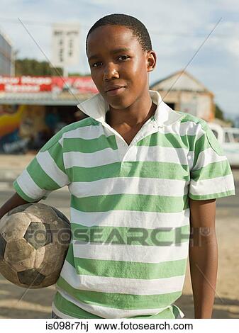 Teenage african boy with football View Large Photo Image Stock Image - Teenage african boy with football. Fotosearch