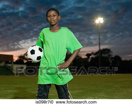 Teenage african boy with football View Large Photo Image Stock Image - Teenage african boy with football. Fotosearch