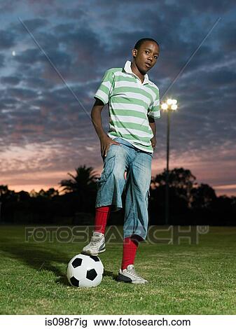 Stock Image - Teenage african boy with football. Fotosearch