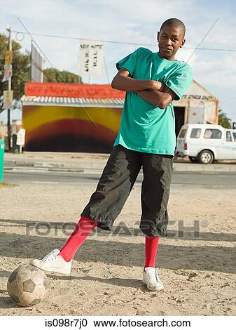 Stock Image - Teenage african boy with football. Fotosearch