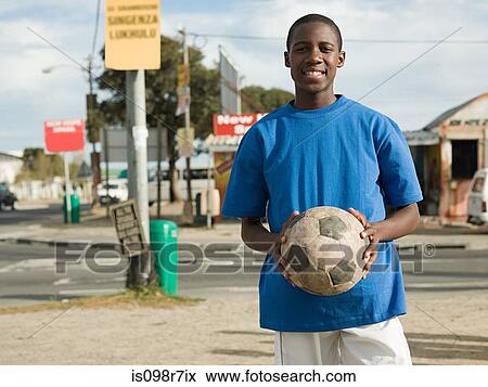 Teenage african boy with football View Large Photo Image Stock Photo - Teenage african boy with football. Fotosearch