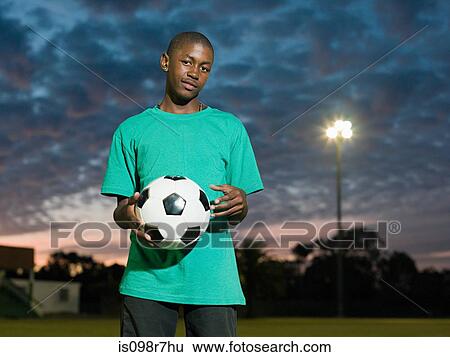 Teenage african boy with football View Large Photo Image Stock Photograph - Teenage african boy with football. Fotosearch