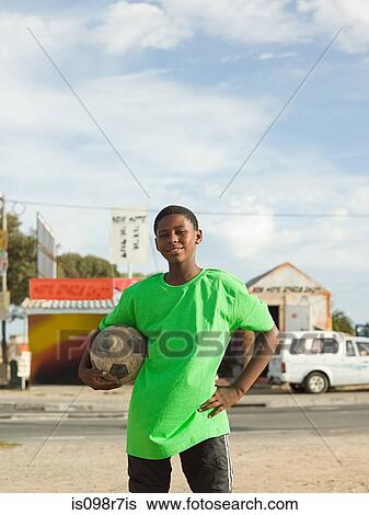 Teenage african boy with football View Large Photo Image Stock Photograph - Teenage african boy with football. Fotosearch