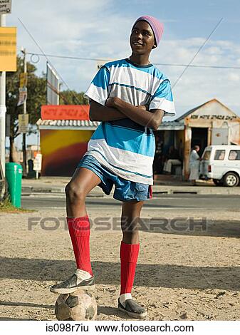Stock Photograph - Teenage african boy with football. Fotosearch