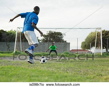 Teenage boys playing football View Large Photo Image Picture - Teenage boys playing football. Fotosearch