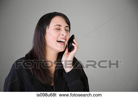 Teenage girl laughing on smartphone View Large Photo Image Stock Photograph - Teenage girl laughing on smartphone. Fotosearch