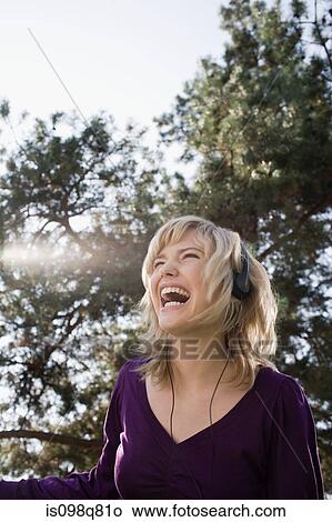 Picture - Teenage girl listening to music. Fotosearch