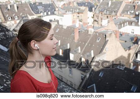 Stock Image - Teenage girl listening to music. Fotosearch