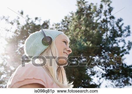 Stock Photography - Teenage girl listening to music. Fotosearch