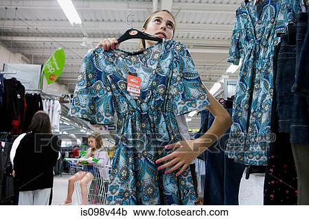 Teenage girl shopping for dress View Large Photo Image Stock Image - Teenage girl shopping for dress. Fotosearch