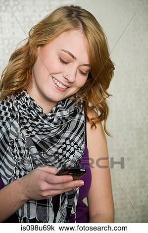 Teenage girl texting on smartphone View Large Photo Image Stock Image - Teenage girl texting on smartphone. Fotosearch