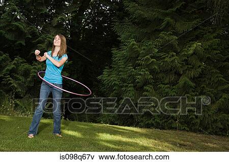 Stock Photo - Teenage girl with plastic hoop. Fotosearch