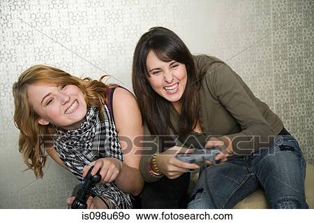 Teenage girls playing on games console View Large Photo Image Picture - Teenage girls playing on games console. Fotosearch