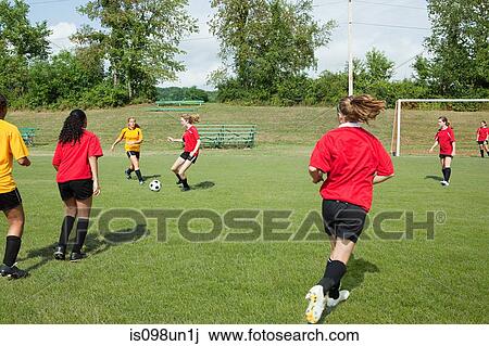 Teenage girls playing soccer View Large Photo Image Stock Image - Teenage girls playing soccer. Fotosearch