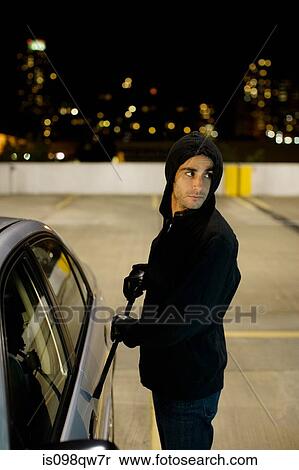 Thief breaking into car View Large Photo Image Stock Photography - Thief breaking into car. Fotosearch