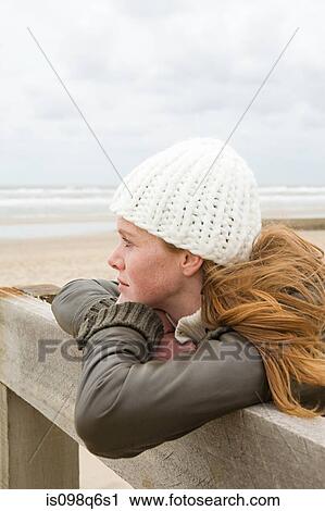 Thoughtful woman by the sea View Large Photo Image Stock Image - Thoughtful woman by the sea. Fotosearch