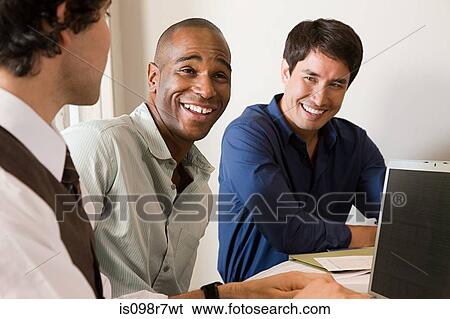 Three male colleagues laughing View Large Photo Image Stock Photograph - Three male colleagues laughing. Fotosearch
