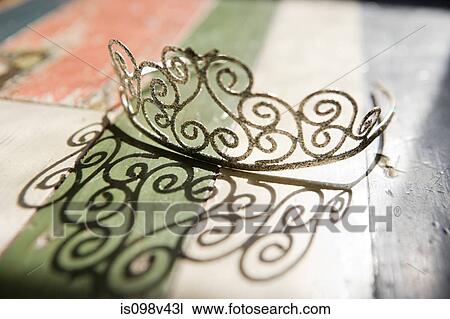Tiara on table casting shadow View Large Photo Image Stock Image - Tiara on table casting shadow. Fotosearch
