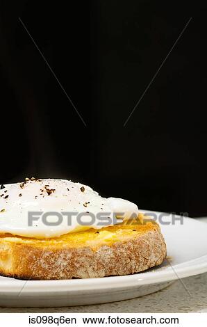 Toast on a poached egg View Large Photo Image Picture - Toast on a poached egg. Fotosearch