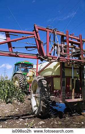 Tractor spraying crops View Large Photo Image Stock Image - Tractor spraying crops. Fotosearch