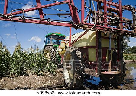Tractor spraying crops View Large Photo Image Stock Image - Tractor spraying crops. Fotosearch