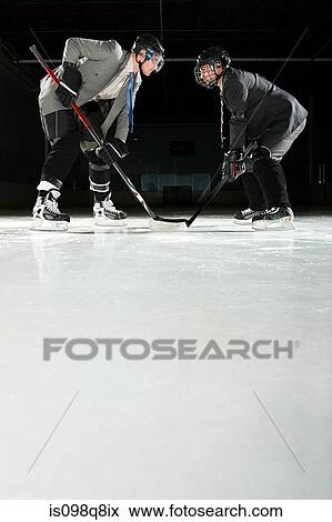 Two businessmen playing ice hockey View Large Photo Image Stock Photo - Two businessmen playing ice hockey. Fotosearch