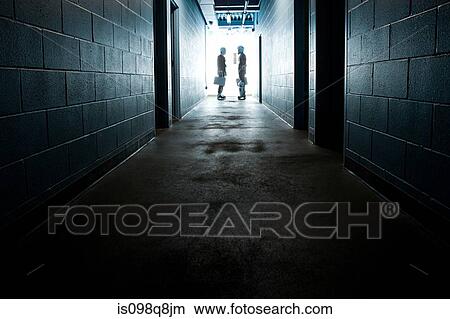 Picture - Two businessmen wearing ice hockey uniforms. Fotosearch