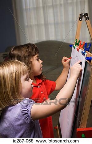 Two girls drawing View Large Photo Image Stock Photo - Two girls drawing. Fotosearch