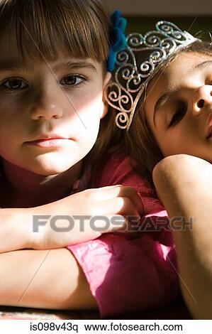 Stock Photography - Two girls, one wearing tiara. Fotosearch