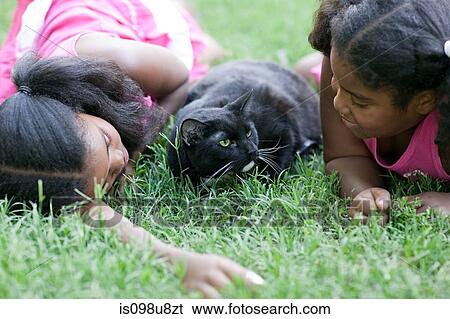 Stock Photograph - Two girls with their pet cat. Fotosearch