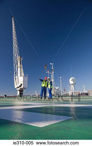 Stock Photography - Two harbour workers on a ship deck. Fotosearch