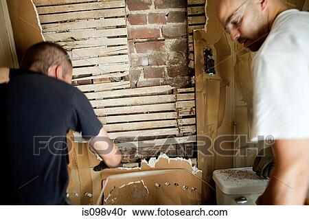 Stock Photography - Two men destroying wall. Fotosearch