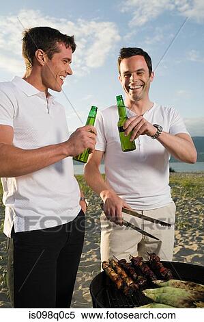 Stock Photography - Two men having a barbecue. Fotosearch
