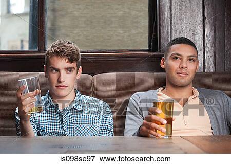 Two young men in bar View Large Photo Image Stock Photo - Two young men in bar. Fotosearch