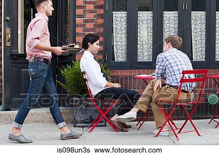 Waiter bringing coffee to men outside cafe View Large Photo Image Stock Photograph - Waiter bringing coffee to men outside cafe. Fotosearch