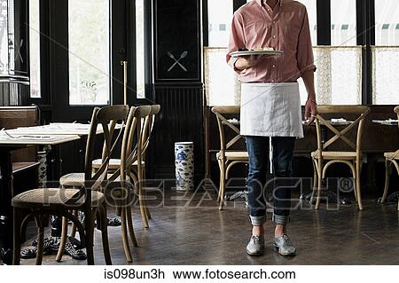 Stock Image - Waiter in coffee shop. Fotosearch